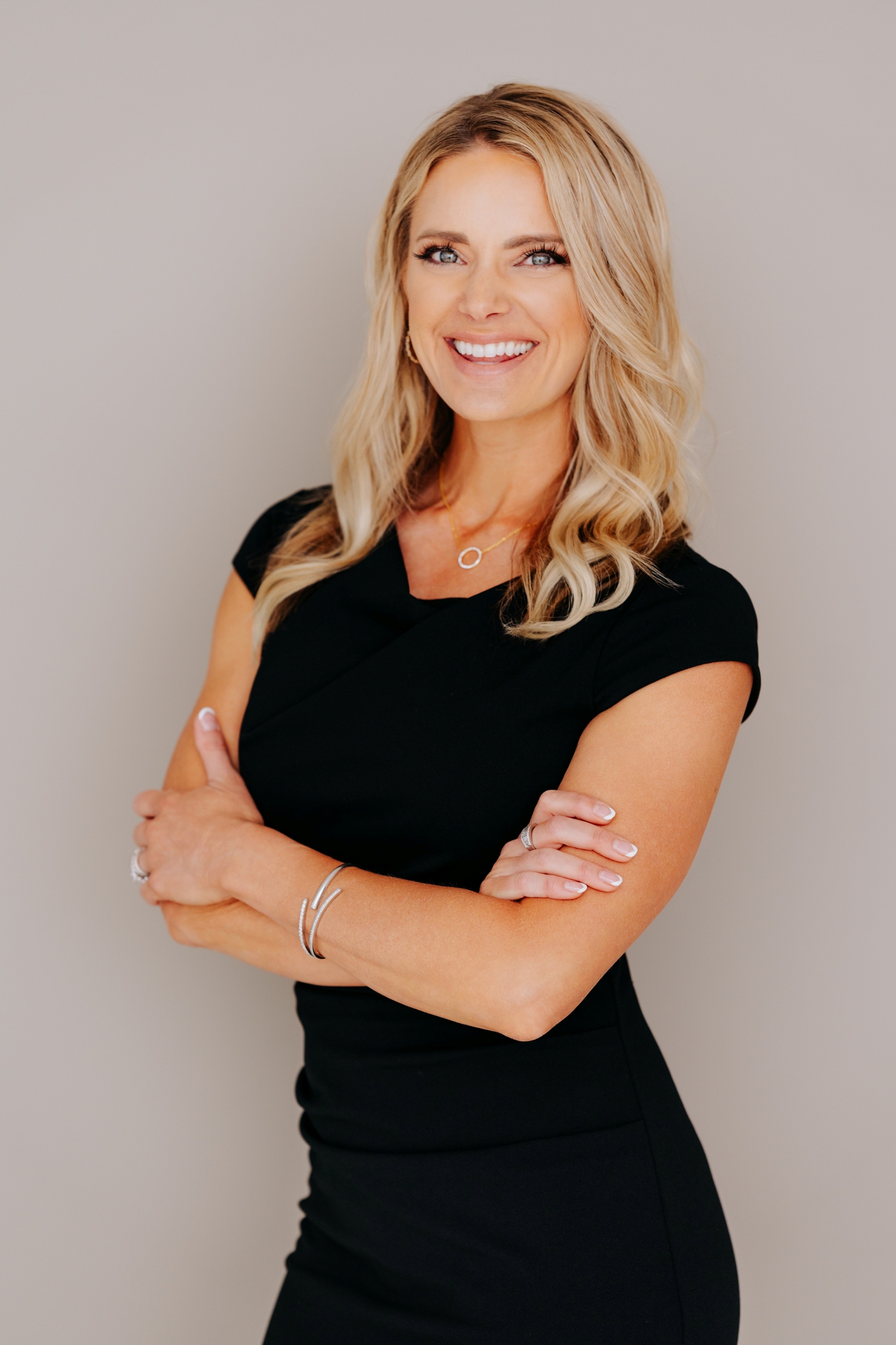 Lynzie standing against tan background
